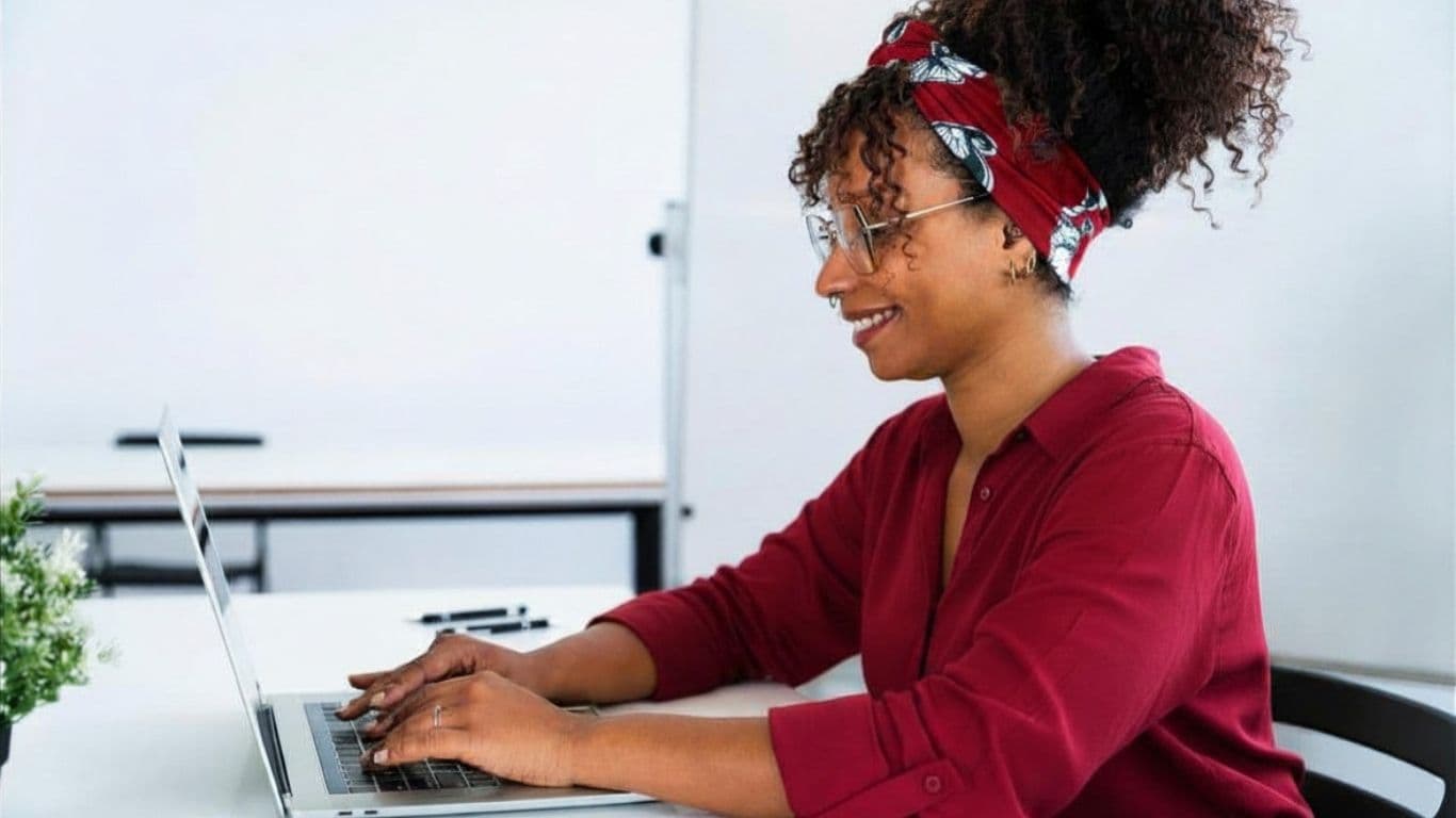 A person watching a virtual session with a diverse panel of participants on screen.